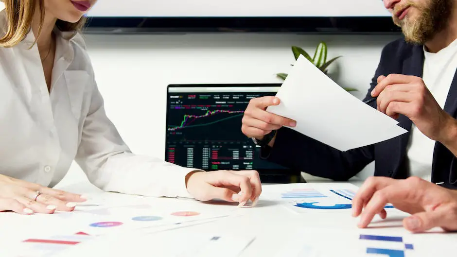 Image depicting a person analyzing stock market data with complex charts and graphs.